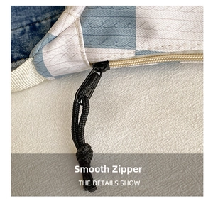 Detail view of smooth metal zipper and blue checkerboard fabric on the chest bag