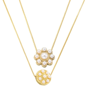 Detailed macro of gold dual-layer necklace with pearl petals and round pendant charms