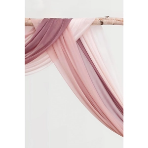 Sheer chiffon wedding arch drapes in pink and purple hung on wood for party decor
