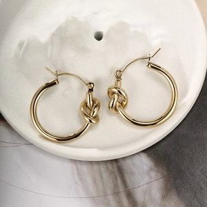Minimalist twisted knot gold stainless steel hoop earrings with polished mirror finish