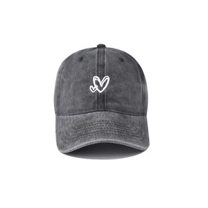 Detailed view of the double heart embroidery on a washed grey cotton baseball cap