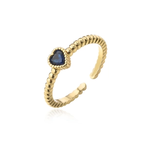 Macro detail of gold plated ring with heart-shaped blue zircon and beaded band texture
