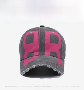 Front detail of washed charcoal canvas baseball cap with pink B-logo and distressed brim