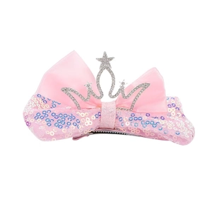 Close-up of pink bow hair clip with luxury sequins and crown detail for girls