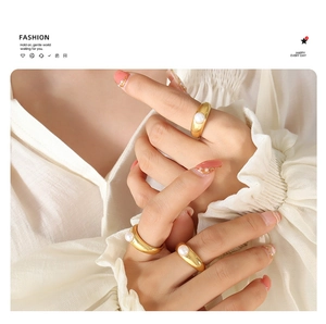 Detail of a gold freshwater pearl ring featuring a bold round band for elegant styling