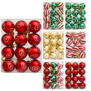 Assorted painted Christmas ball ornaments in red, gold, and green for tree decoration