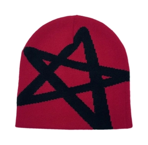Close-up of red knit beanie featuring black star pattern and high-quality fabric texture