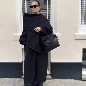 Oversized black wool blend coat with scarf detail and leather handbag in street style