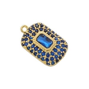 Macro shot of rectangular blue gemstone pendant with gold frame and micro-pavé crystals