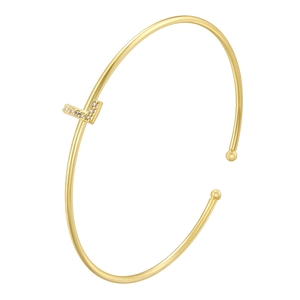 Detail of gold-plated cuff bangle featuring a V-shaped charm set with sparkling zircons