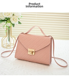 Detail view of pink woven envelope crossbody bag with a gold metal square lock