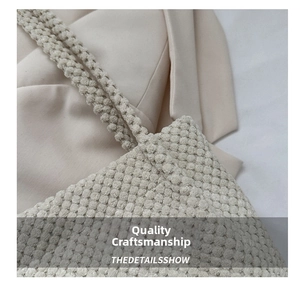 Detail shot of beige popcorn textured tote bag showing high-quality fabric and soft handle