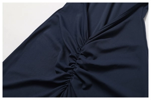 Close-up of ruched texture and V-neckline detail on navy blue high-stretch yoga jumpsuit