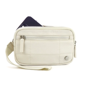Detail showing cream nylon wristlet bag with zipper and phone inside for scale