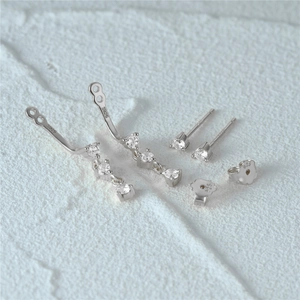 Macro detail of S925 sterling silver stud earrings with sparkling cubic zirconia stones