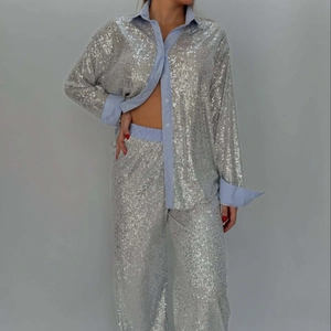 Chic silver sequin suit set with blue striped cuffs and wide leg trousers for women