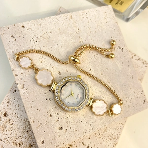 Elegant gold flower bracelet watch with rhinestone bezel and white mother of pearl inlay