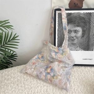 Detailed close-up of a floral chiffon tote bag with SOSIAIKA CANVAS STUDIO brand label