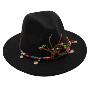 Detailed shot of black wool fedora featuring ethnic beaded band and natural seashells