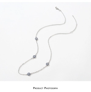 Detailed view of s925 silver chain with blue evil eye charms and lobster clasp