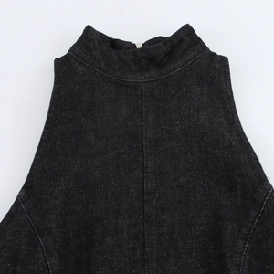 Detail of the high collar and metal button on back of black denim sleeveless dress