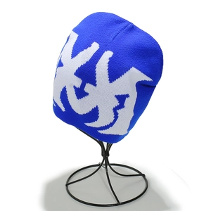 Close-up of royal blue knitted beanie featuring detailed white abstract jacquard patterns