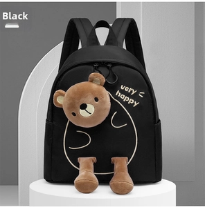 Detail of lightweight black kindergarten backpack with a cute plush 3D bear decoration