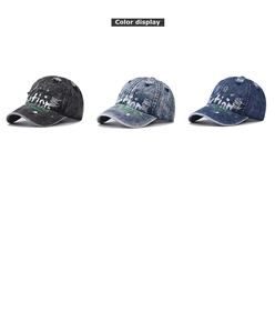 Detailed view of washed denim baseball caps with graffiti prints in three vintage colors