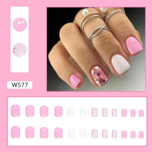 Short pink and white press-on nails with glitter accents and glossy sweet finish
