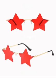 Detail of star-shaped rimless sunglasses with gold metal frame and red oceanic lenses