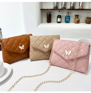 Detailed view of quilted crossbody bags with golden butterfly buckles in three colors