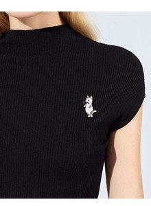 Detail of a cute white and grey cat brooch catching a gold fish on a black sweater