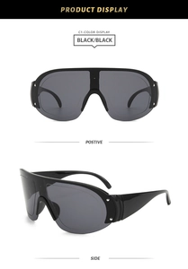 Macro detail of black wraparound sunglasses with side silver rivet accents and wide temples