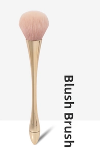 Close-up of fluffy pink fiber bristles on a champagne gold metal blush brush