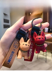 French Bulldog keychains in brown and dark red with BOOM! slogan leather straps
