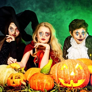 Three models wearing 3D Halloween face gems with pumpkin and green smoke background