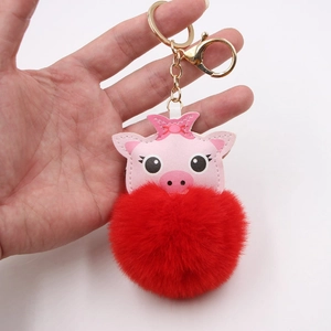 Cute pink pig keychain with red plush pom-pom and gold metal ring for bags