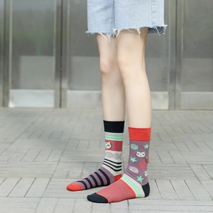 Outdoor shot showing mismatched cotton crew socks with cat and strawberry patterns