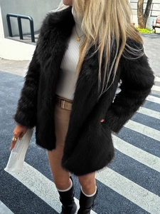 Close-up of black faux fur coat with soft texture and glossy finish for elegant winter styling