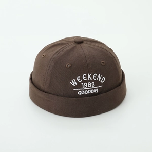 Close-up of Weekend 1983 embroidery on dark brown canvas docker miki hat for kids