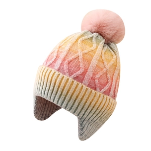 Winter tie-dye gradient knit hat for kids with ear flaps and a fluffy faux fur pompom