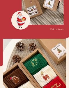 Detail of Christmas gift box featuring socks with gingerbread and reindeer embroidery