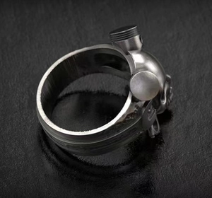 Detailed close-up of a punk mechanical skull ring with brushed metal texture and industrial pistons