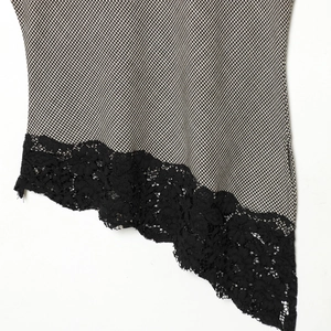 Houndstooth sleeveless top with irregular black lace hem and detailed fabric texture