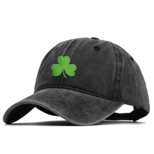 Close-up of green shamrock embroidery on a black washed cotton vintage baseball cap
