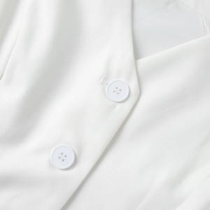 Detailed macro shot of white twill fabric and matching round buttons on suit vest