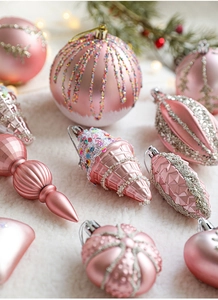 Pink Christmas ornaments collection with star and heart shapes on white fur background