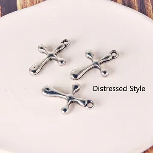Detailed view of three antique silver cross pendants with vintage black finish and retro style