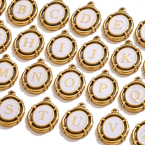 Detailed grid of golden oval alphabet pendants with white enamel inlay for DIY jewelry