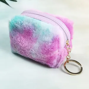 Detail of soft tie-dye plush heart coin purse with golden metal zipper and key chain ring